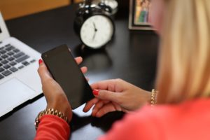 Woman working looking at smartphone