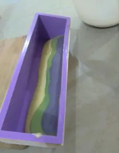 Adding soap in layers to soap mold
