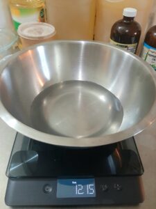 Weighing water to make handmade soap